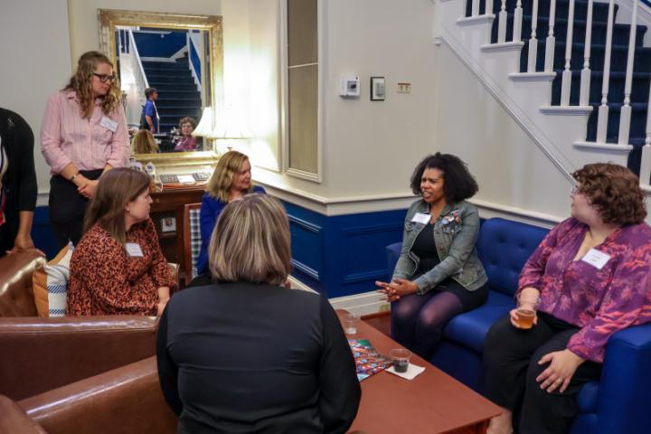 A group of people on chairs and couches chatting